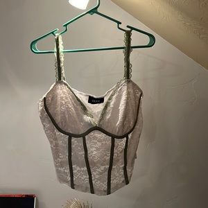 Lacy white faux corset style tank top with green trim
